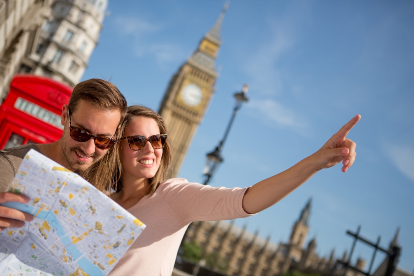 Couple of tourists in London holding a map