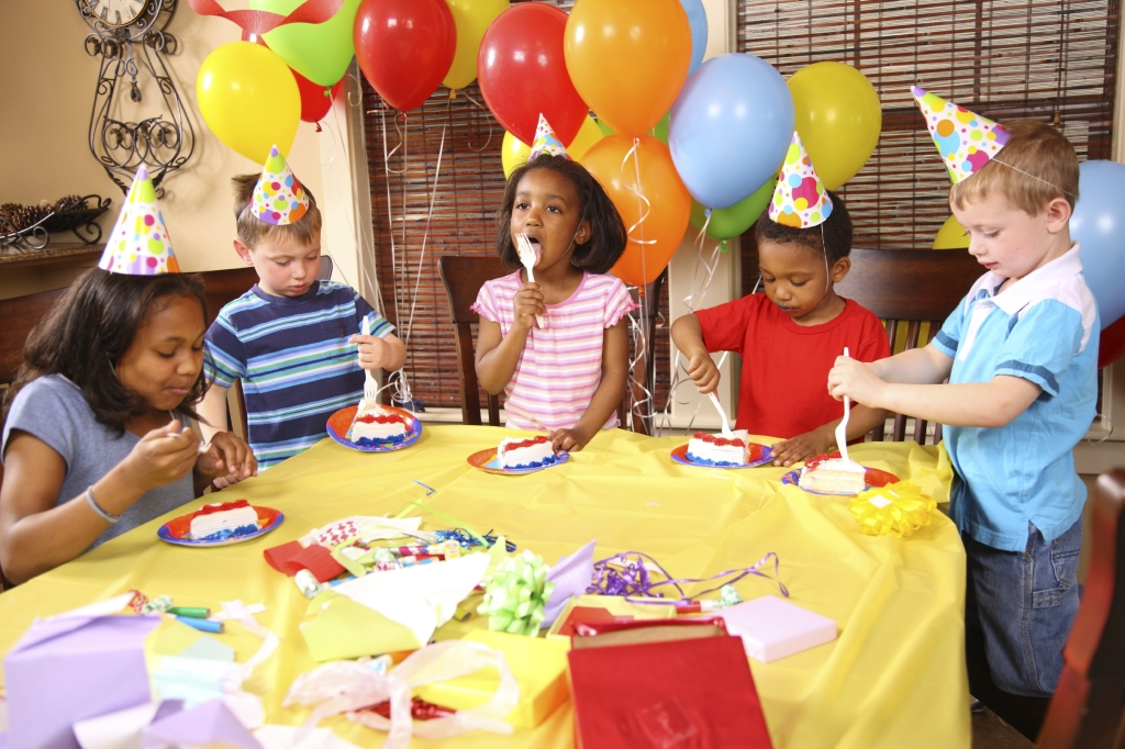 Group of children eating cake at birthday party